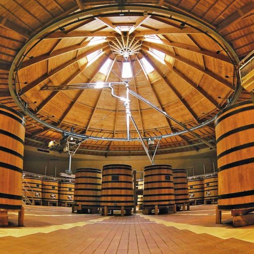 Louis Jadot Cellier de la Sabliere Beaune winery - a circular wooden ceiling supports the rotating filling pipe that supplies grape juice to awaiting wooden fermenters on the floor below