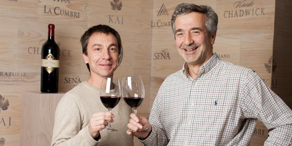 Francisco Baettig and Eduardo Chadwick touch red wine glasses in a toast to Errazuriz