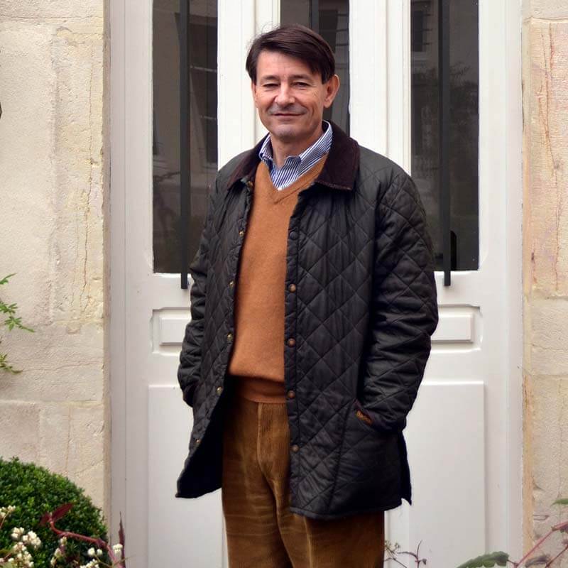 Pierre-Henry Gagey, Louis Jadot President, standing in front of a white door of the Jadot home in Beaune