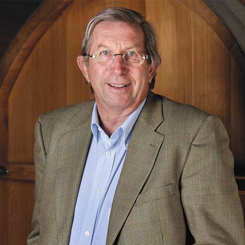 Chris Hancock MW (Honorary), Deputy Executive Chairman, portrait image, taken in front of a large barrel.