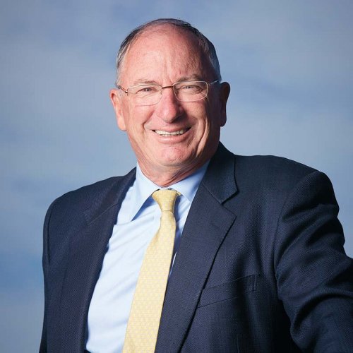 Sandy Oatley, Executive Chairman, portrait image, dressed in navy jacket and gold tie