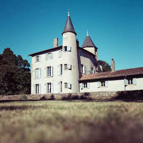 The Château de la Terrière against a clear blue sky, has been in Cercié, Beaujolais, France since the 16th century