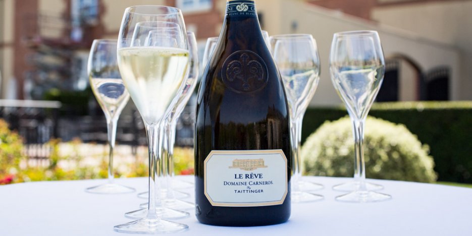 Le Rêve Blanc de Blancs Brut bottle and glasses on an outdoor table at Domaine Carneros