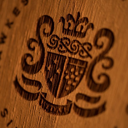 Close up of a wooden barrel end branded with the Vidal crest