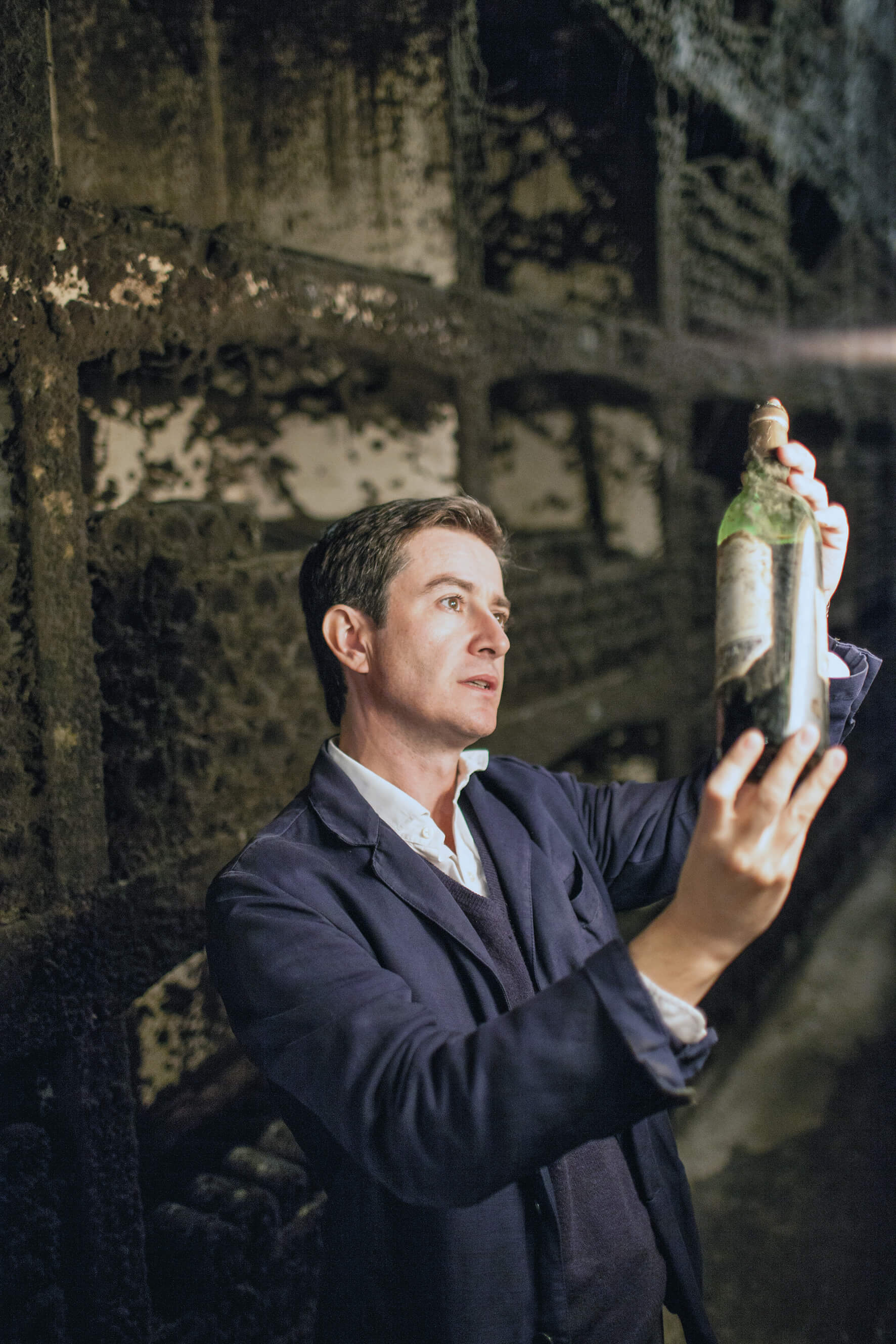 Victor Urrutia - CEO of C.V.N.E. in the vintage cellar inspecting a dusty bottle of Imperial