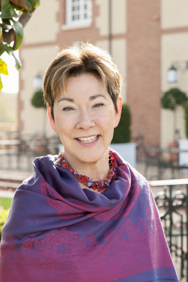 Eileen Crane, wearing a purple shawl, stood in front of the winery. Image credit Avis Mandel Pictures.