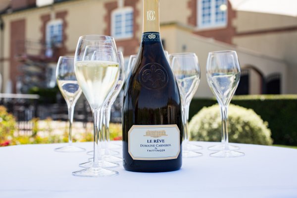 Le Rêve and glasses on a winery terrace table