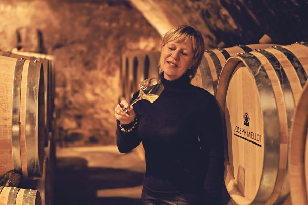 Catherine Corbeau-Mellot inspects progress of white wine ageing in the cellars