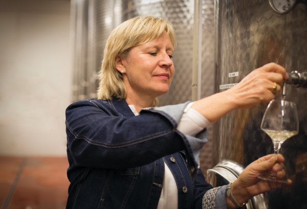 Catherine Corbeau-Mellot inspects progress of white wine fermentation in the winery