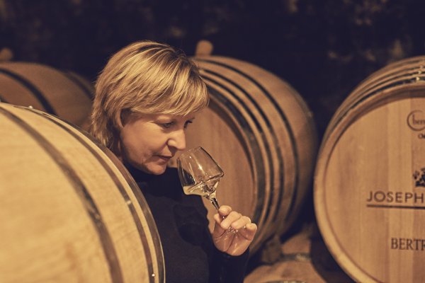 Catherine Corbeau-Mellot checks the aromas of a white wine sample pulled from the cask in the cellar