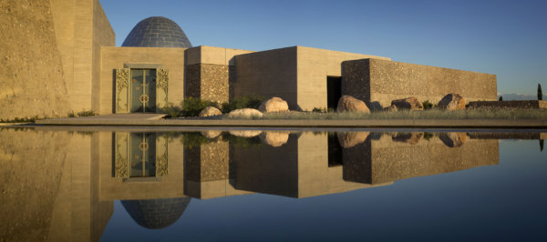 Valle de Uco Winery reflecting in the still water outside the front facade