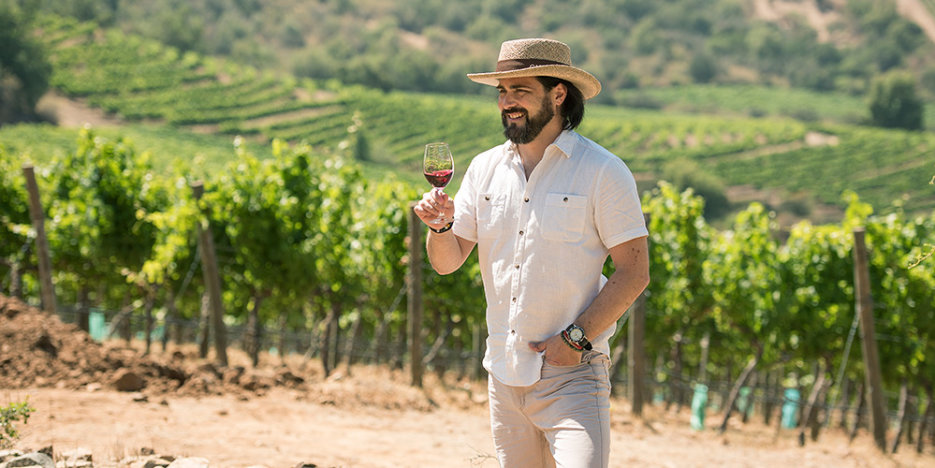 Rodrigo Zamorano - Chief Winemaker - in the vineyard, short sleeved white shirt, and pale gaucho hat
