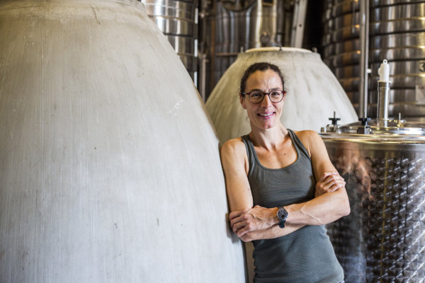 Domaine Ferret winemaker Audrey Braccini leaning against concrete fermenter