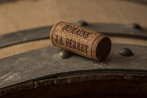 Domaine J A Ferret branded cork on barrel in winery