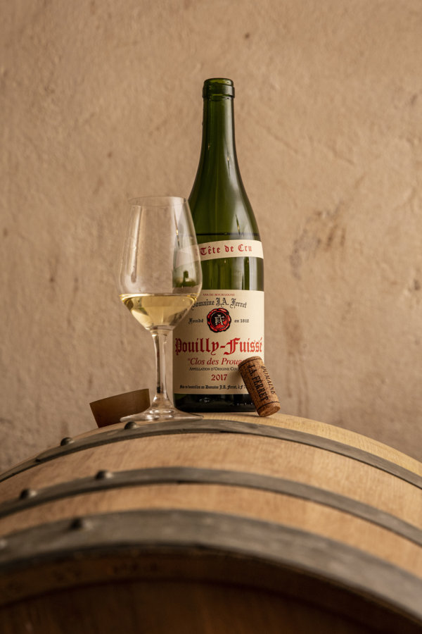 Domaine Ferret Pouilly-Fuissé Clos des Prouges and glass standing on a barrel in the winery