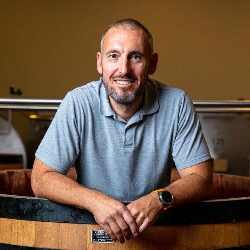 Frédéric Barnier, Jadot Winemaker, stood in a wooden fermenter at the Beaune Winery